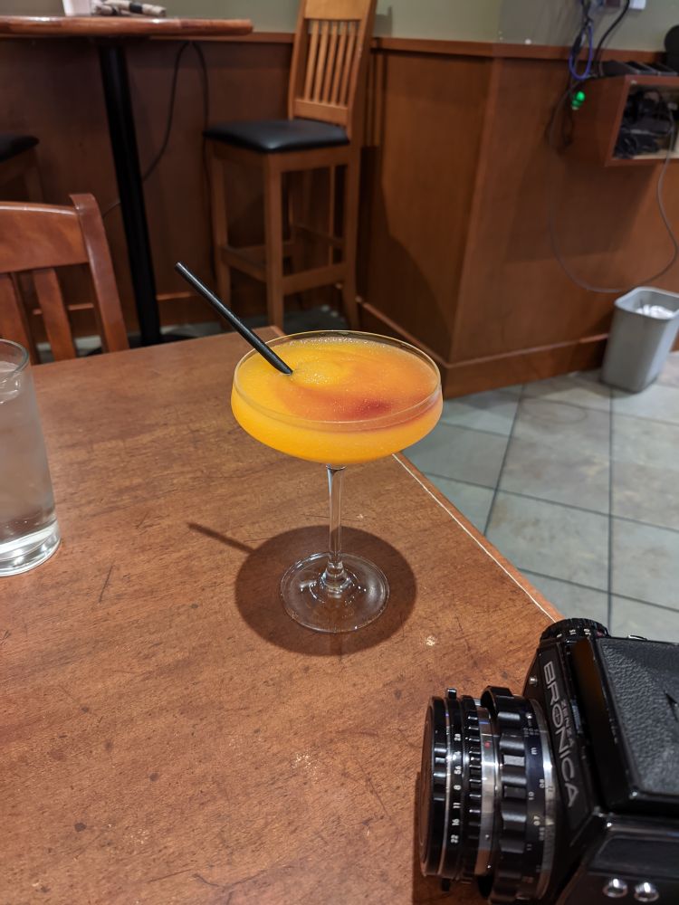 A photo of a peach bellini (with my Bronica visible in the corner of the frame, as usual >.> )