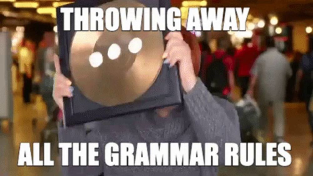 a person throwing away all the grammar rules while holding a cymbal in front of their face