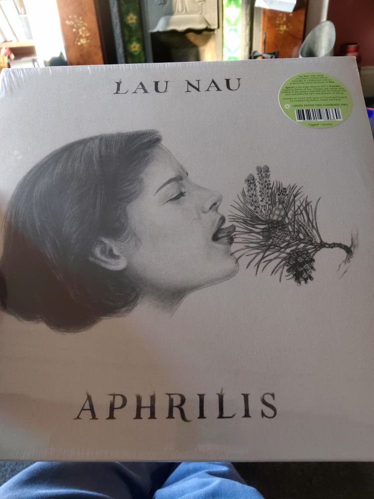 Cover of the album "Aphrilis" by Lau Nau. The art is a pencil drawing of a woman licking a spray of pine (or larch?) needles, which appears to be flowering.