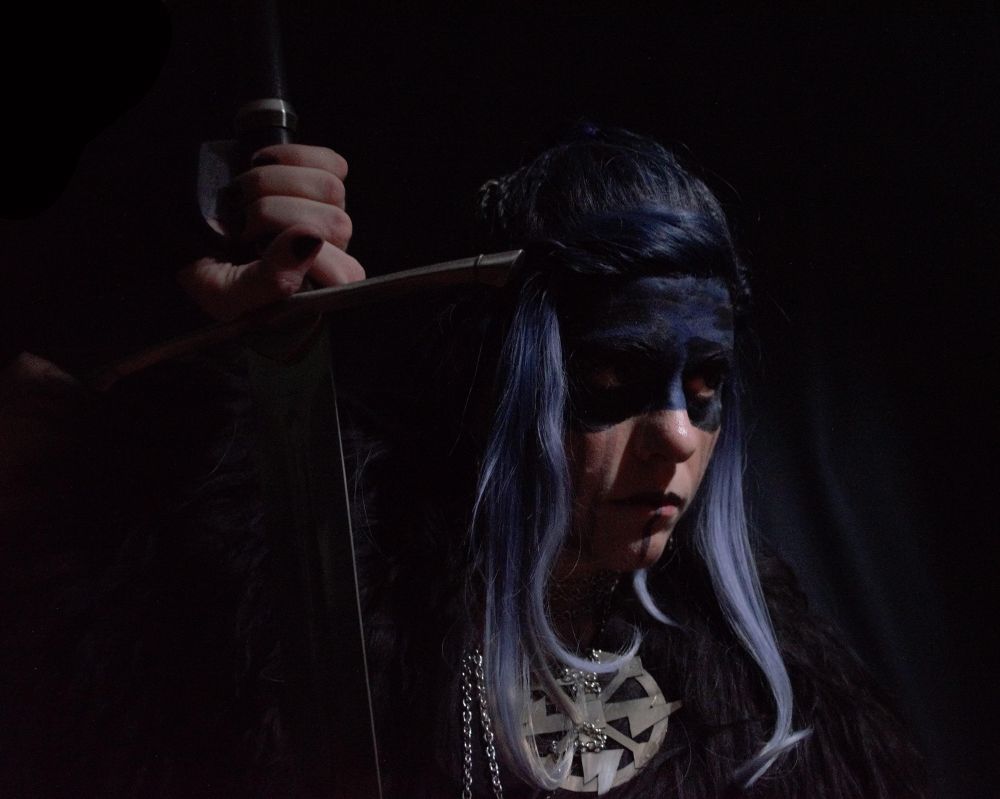 Another shot from the same set. This time I am facing to the right, hand on the hilt of the sword as if I am about to stand up and swing it. You can see Yasha's holy symbol, a sort of round shield shape with lightning, hanging by tangled chains around my neck