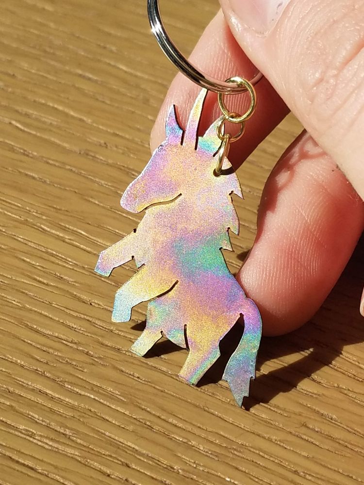 A keychain in the shape of a tiny fat unicorn. It's made out of anodized titanium so it's a sort of rainbow color