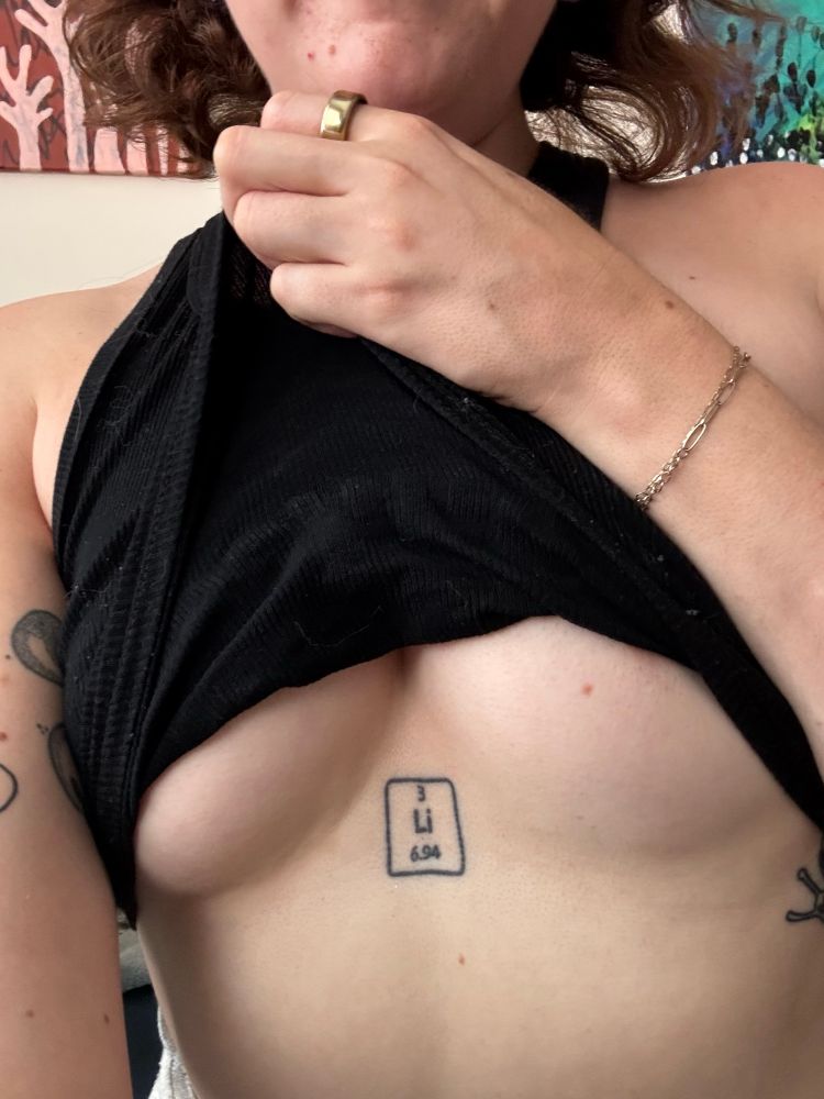 selfie image of my chest, as i pull my shirt up to expose my breasts 