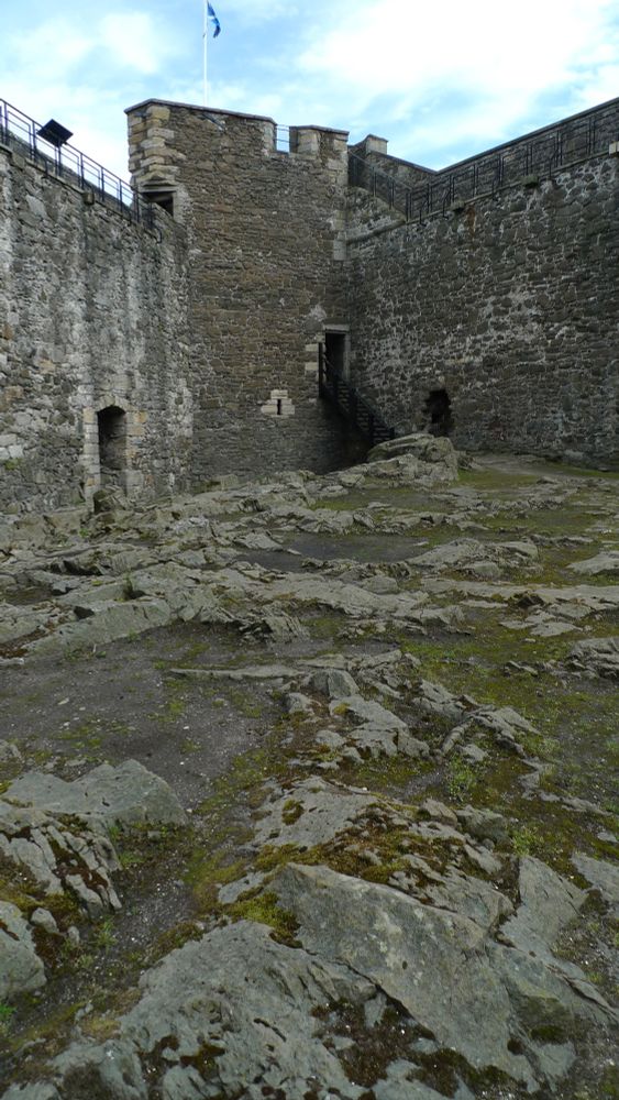 Inside the courtyard of Blackness Castle. The ground is uneven and rocky