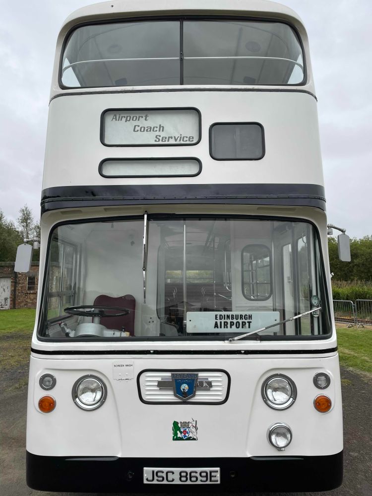 A vintage double decker bus with destination board for Edinburgh Airport