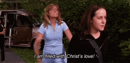 SAVED scene where actress, Mandy Moore, yells, “I am filled with Christ’s Love!” while throwing a bible at actress, Jenna Malone’s back.