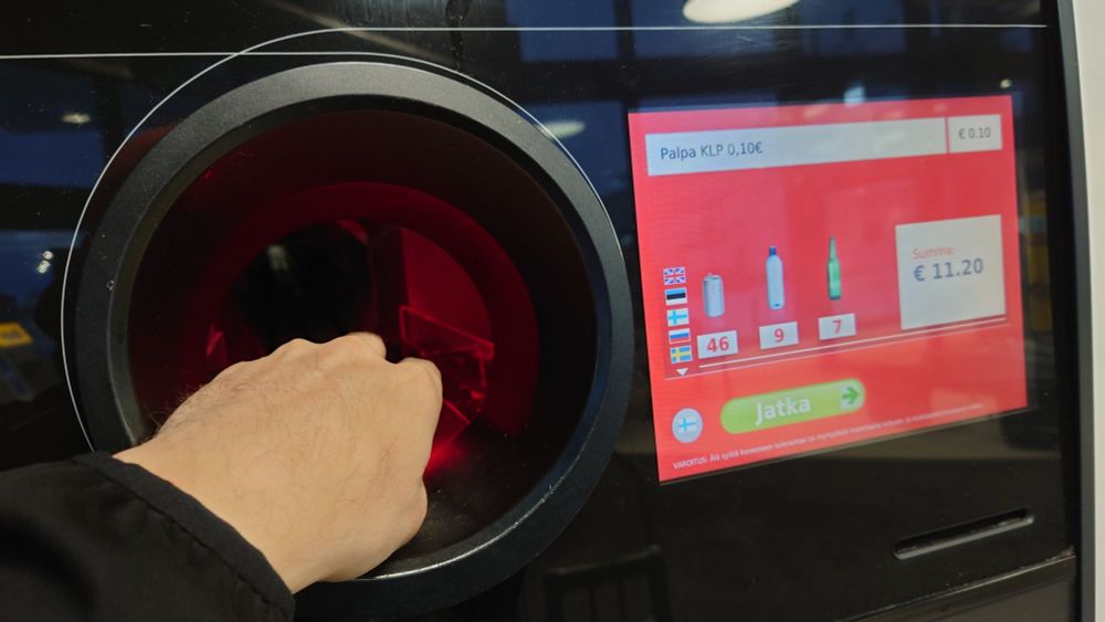 Inserting bottles to the machine. Already 11.20 eur total refund.