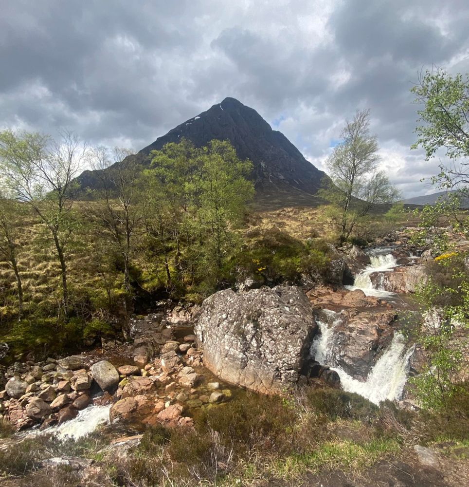 The Buachaille Etiv Mòr in the scottish highlands with a running stream in the foreground.