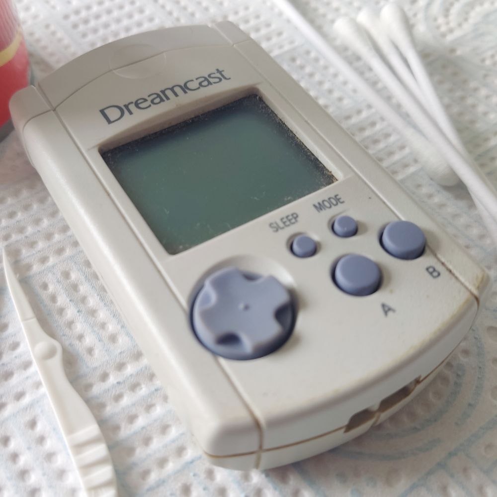A grubby looking memory unit for the Sega Dreamcast 