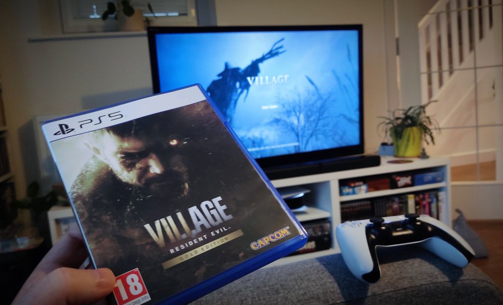 The box for Resident Evil Village and it running on my TV