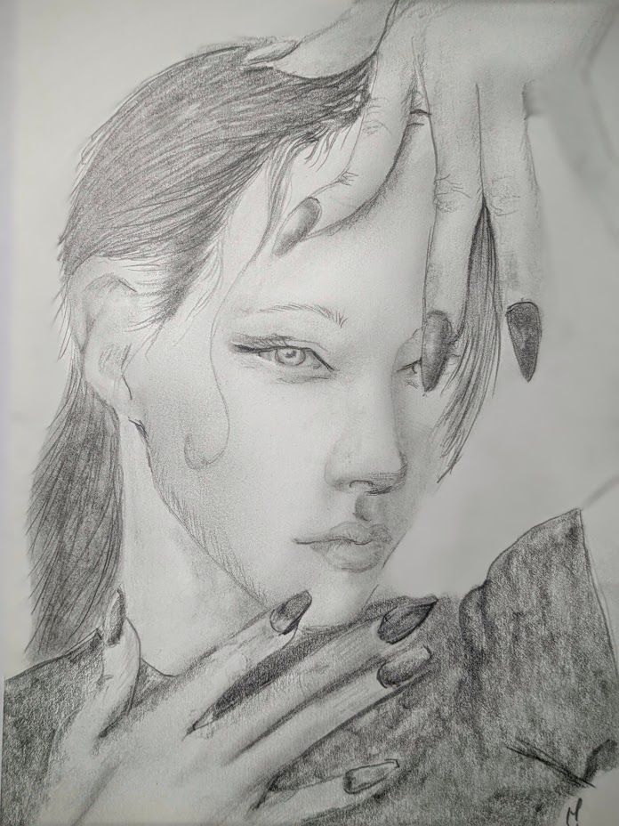 Graphite portrait of an androgynous person with long nails looks at the viewer. Their hands frame their face, with their long fingers tipped in dark coffin-shaped nails, spreading. Their dark hair is swept back and flows down their back.