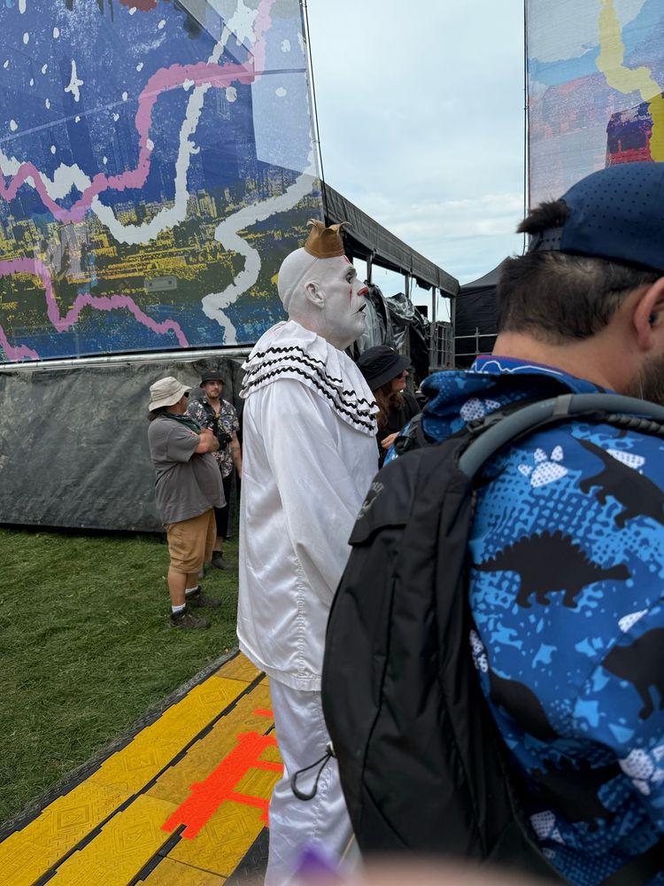 Puddles, a clown, listening to a band