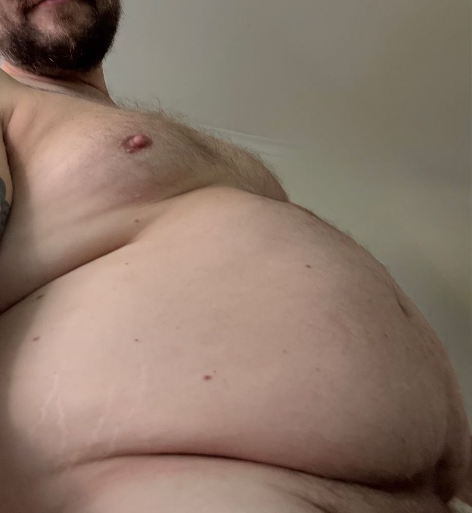 A big fat hairy belly hanging out with perky nipples and a beard