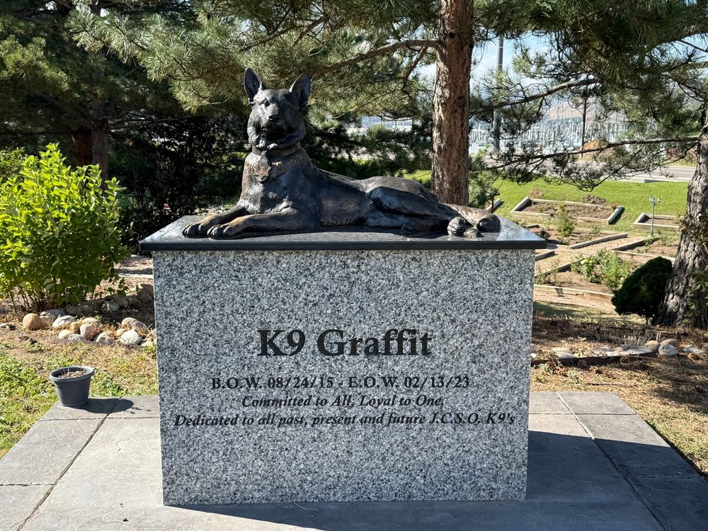 Memorial to K9 Graffit, located at Jefferson County Sheriff's Office in Colorado. Statue of dog on a granite block that says 