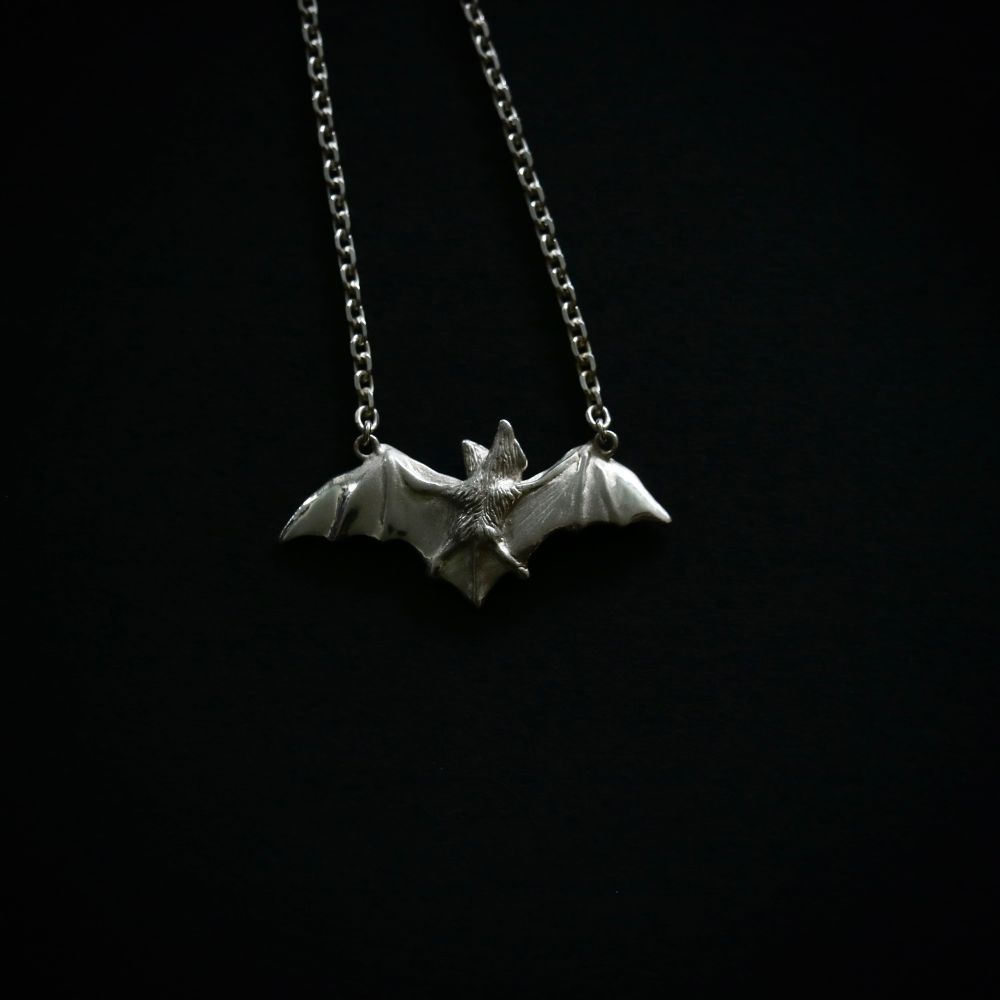 Reverse of the Sterling silver bat necklace, highlighted the bats butt. 