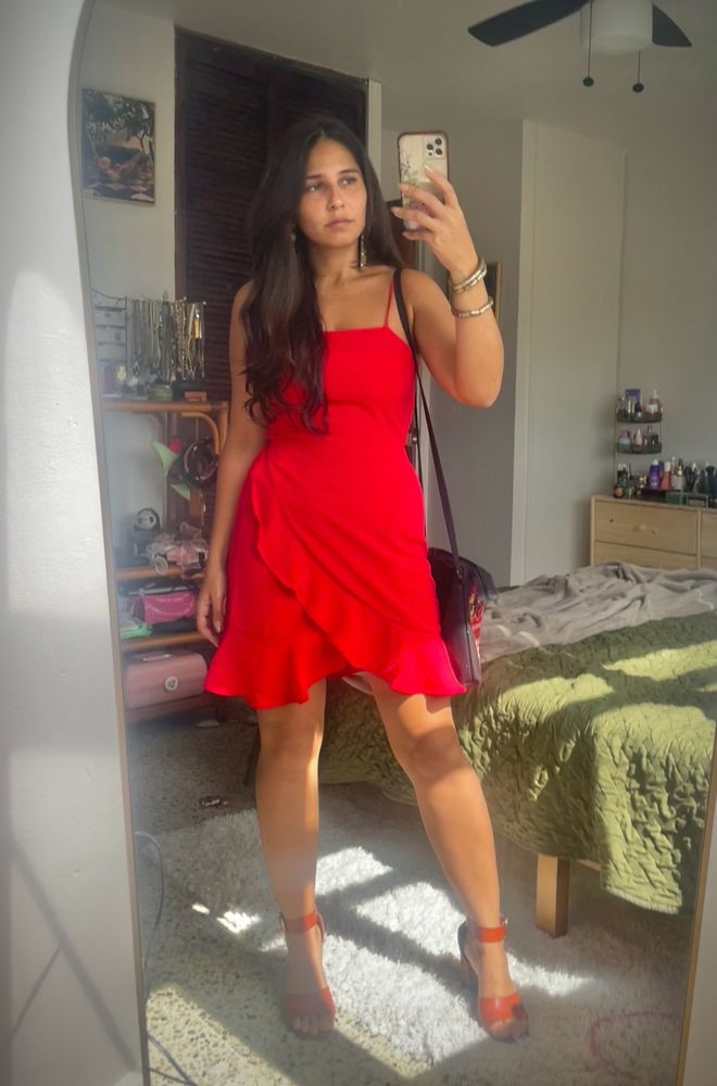 nb femme in a red dress taking a mirror selfie 