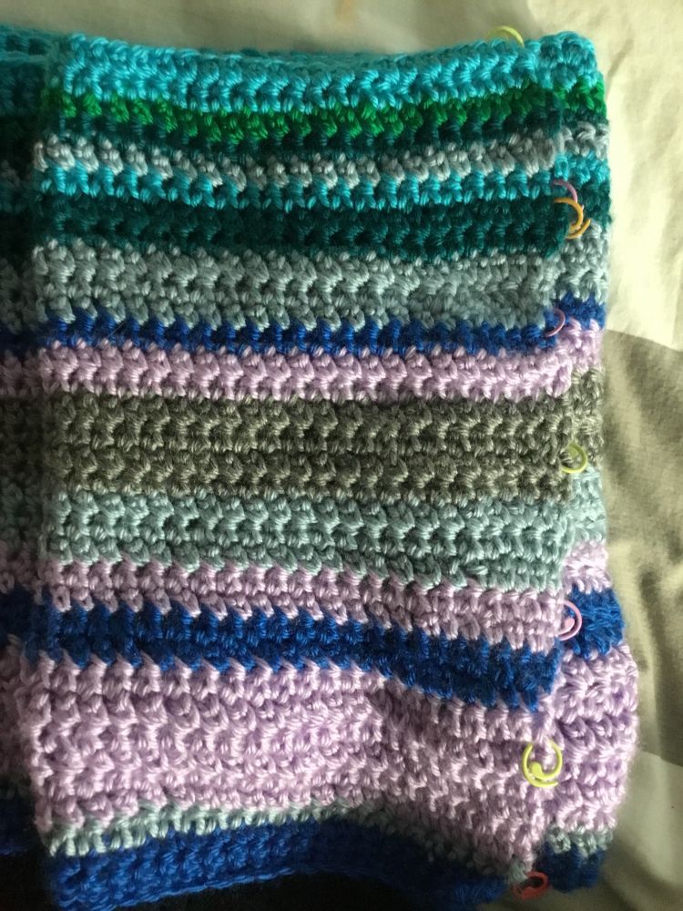 Blanket in purple, blue, grey, and green. January temperature blanket for 2025