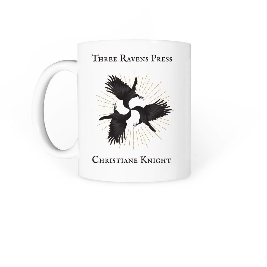 A white coffee mug with three flying black ravens that meet at the beaks in a design that hints at Celtic animal designs. There's a starburst of golden energy behind the ravens. Above the design is text that says Three Ravens Press and under it reads Christiane Knight.