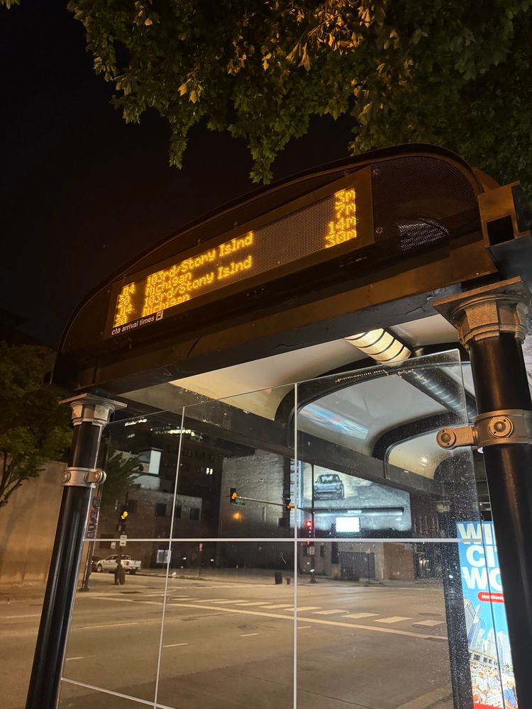 a snap of a cta bus stop with its digital display showing which lines of buses will arrive in how many minutes:
j14 in 3 mins
20 in 7 mins
etc.