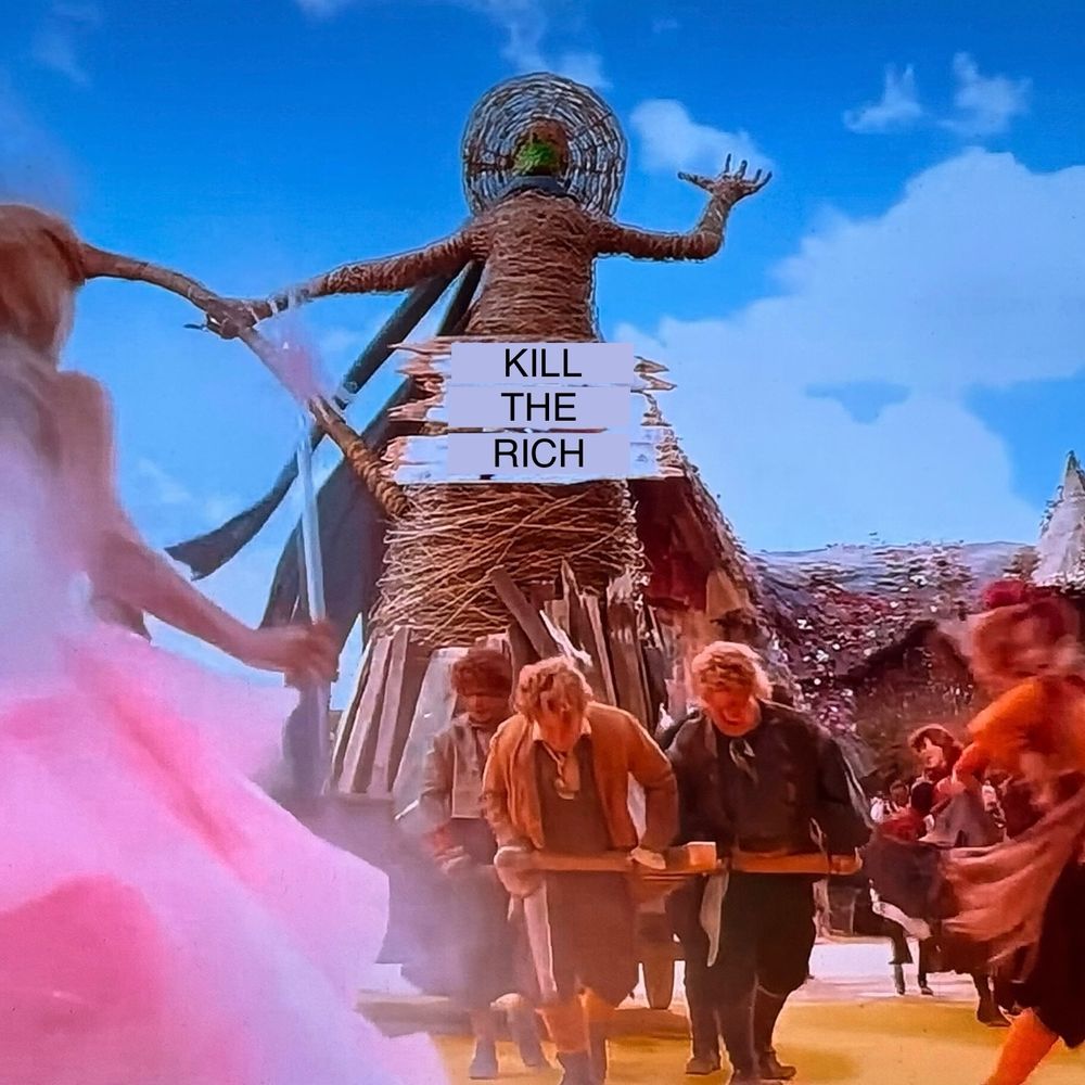 An effigy of the witch from wicked with a sign on the front that says kill the rich. 