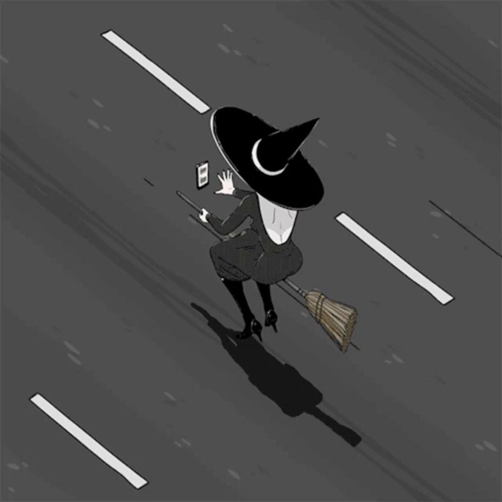 a woman in a witch hat is riding a broom down a road