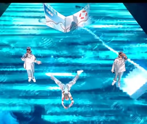 a person "swimming" on the Eurovision stage using a skateboard. 
This shot is the perspective of the official broadcast