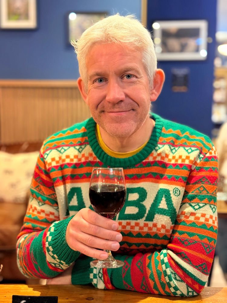 Picture of me now (Sep 25) at 50kg lighter - and wearing my Abba sweater and holding glass of red wine 