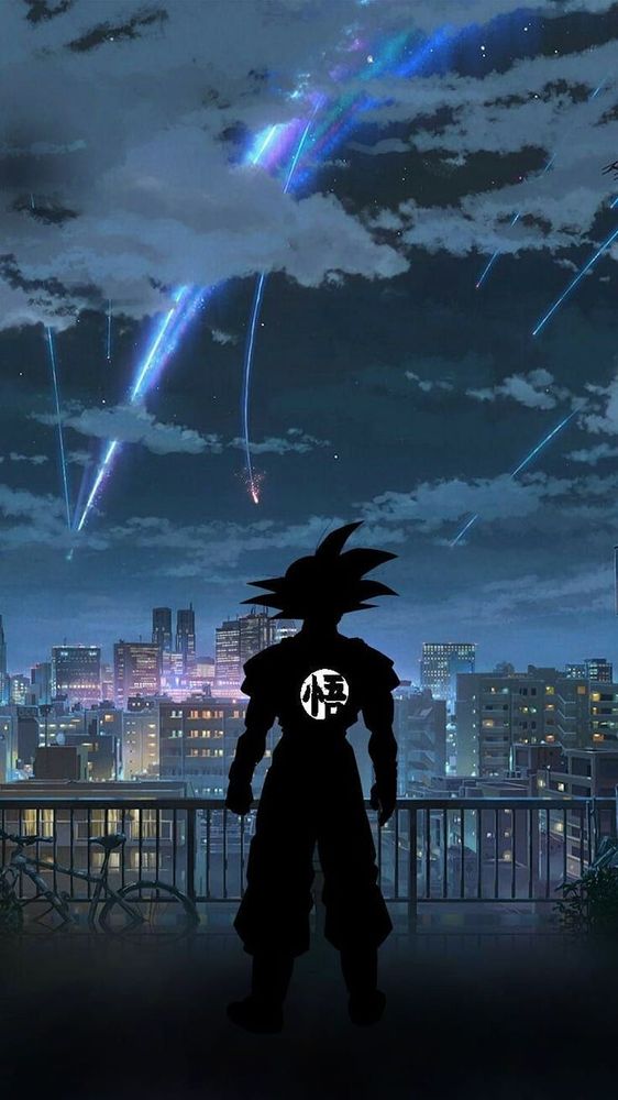 Goku in silhouette looking out onto a city at night full of lights. 