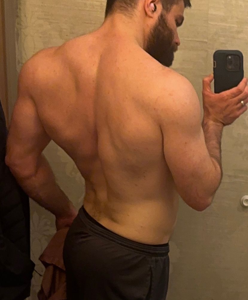 Shirtless mirror photo of my back after a pull day