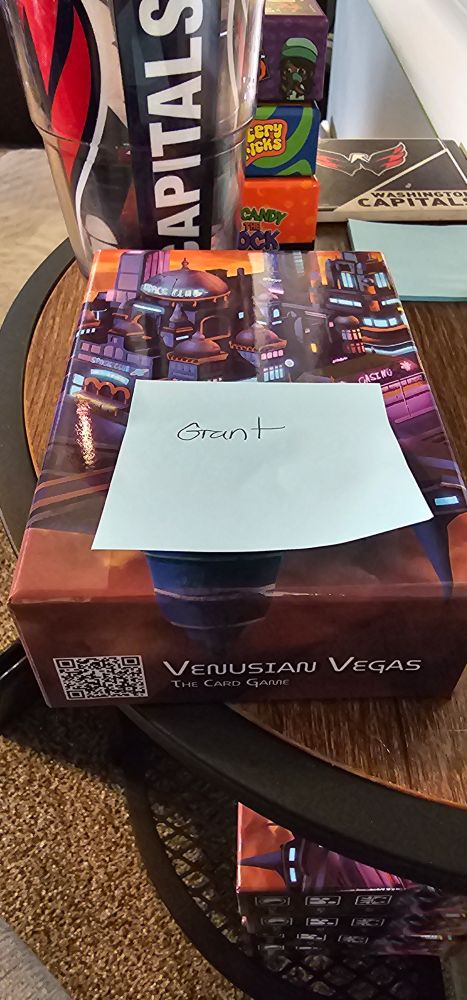 Venusian Vegas The Card Game box with a tag on it that says Grant