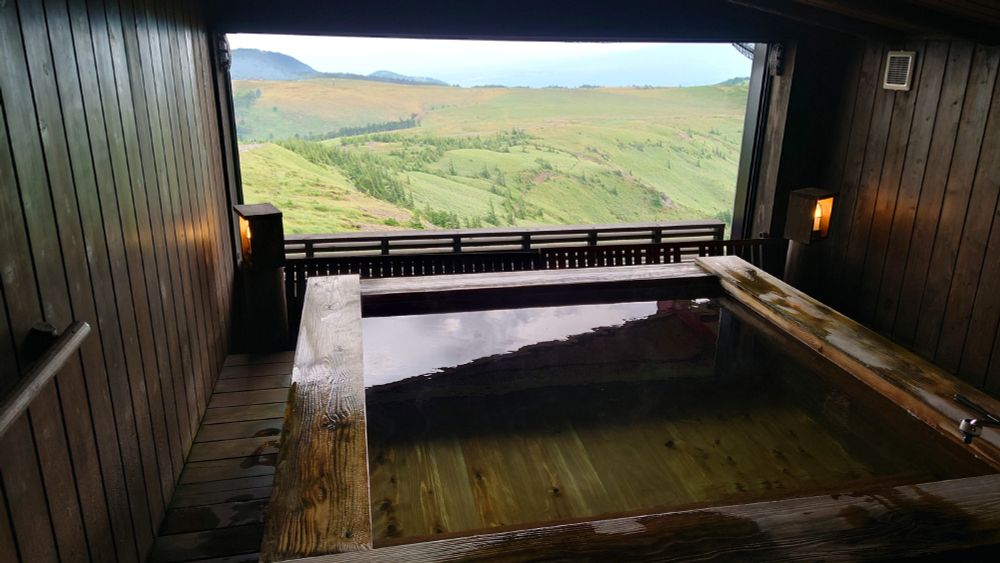 Private open-air bath with view of the highlands at the hotel.