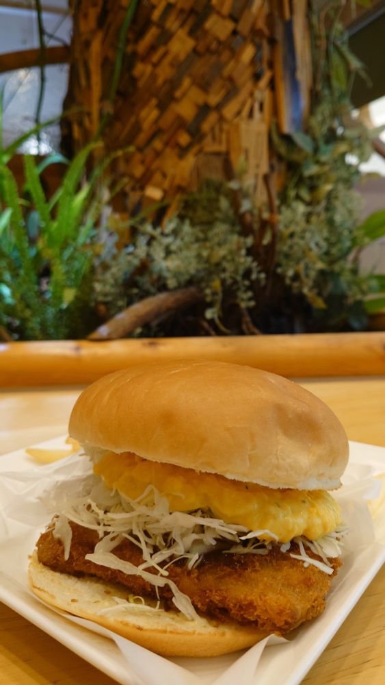 Chicken tartar burger, with vegetation in the background