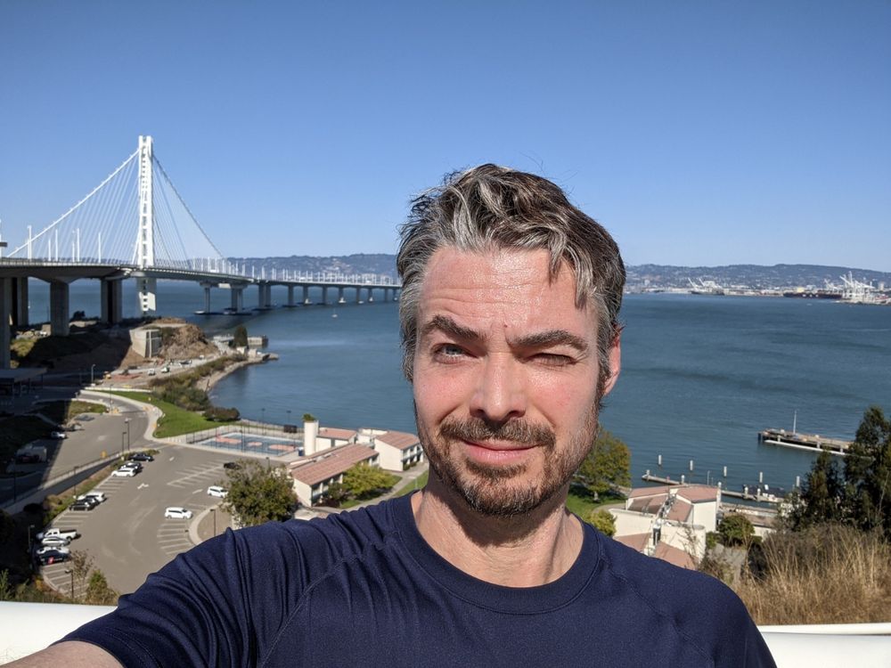Selfie with background of the bay bridge and east bay