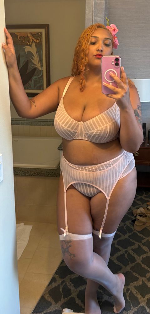 Mirror selfie of me in light pink striped bra, panties, and garter with light pink stockings. 