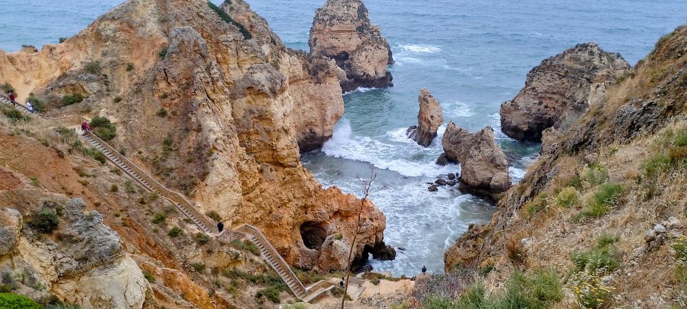 steep set of steps leading down a cliff to the sea in the Algarve, Portugal