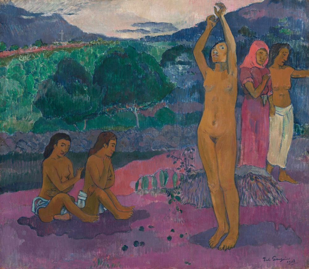 The painting portrays five women with brown skin situated in a vibrant landscape. At the center-right, a nude woman stands with her arms raised overhead, gazing upward. To her left, two women, clad only in pale blue cloths around their waists, sit side by side, looking downward with arms crossed over their chests. On the far right, another pair of women move toward the painting's edge; one wears a dusky rose-pink dress with a bright coral-pink head covering, while the other is bare-chested with a white cloth around her waist, gesturing off the canvas. The background features a band of lush vegetation leading to cobalt-blue mountains under an ivory-white sky.