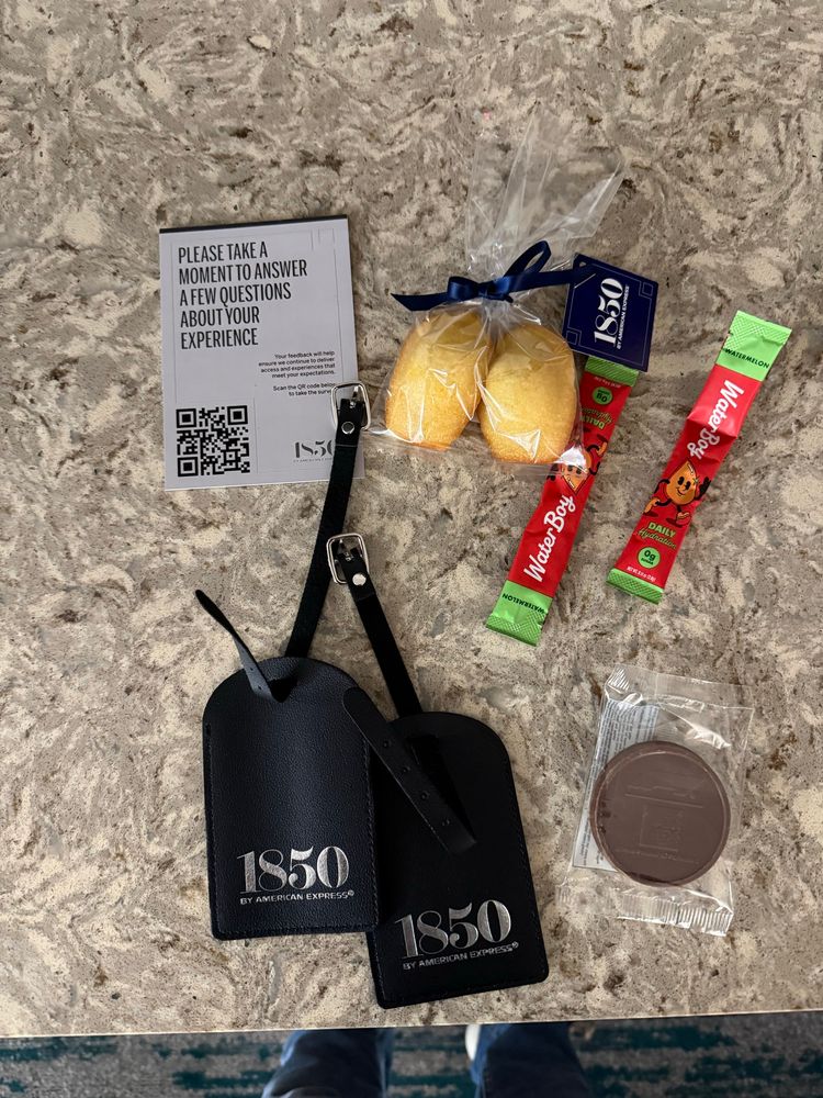 1850 by American ecpresss luggag tag, chocolate cookie with F1 printer on it, water boy hydration, and baked cakes
