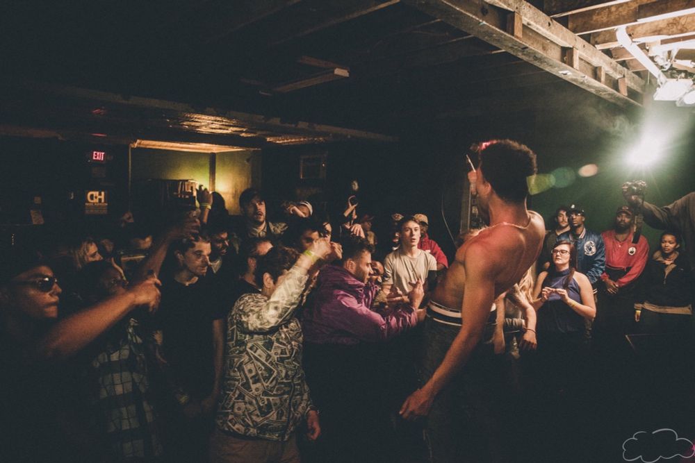 sidmfkid performing in a small venue