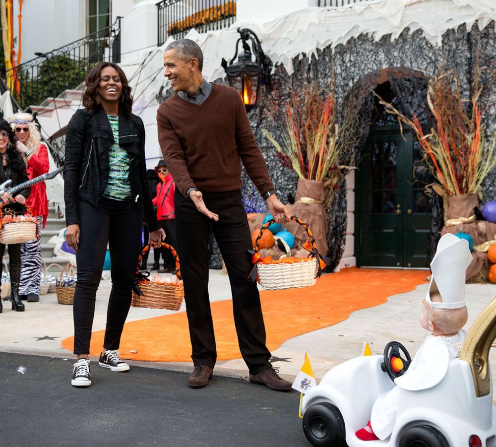 President Obama very clearly saying “Michelle, look at this baby Pope!” Michelle Obama is also laughing 