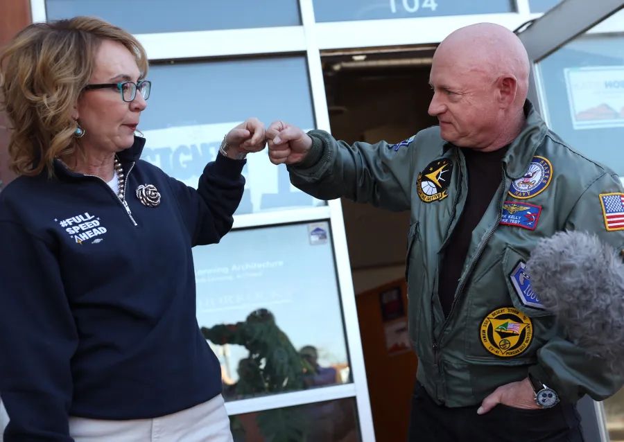 Captain/Senator Kelly affectionately fist bumping Gabby Giffords.