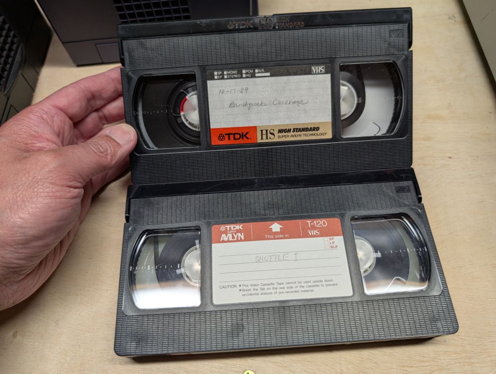 Two VHS tapes. One labeled 10-17-89 Earthquake Coverage and the second is labeled Shuttle I