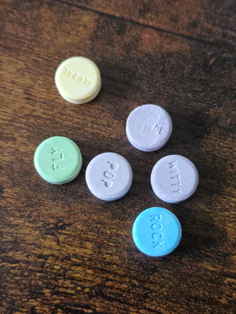 several SweetTarts with inspirational words, one of which came out of the box scuffed so it just says ICE