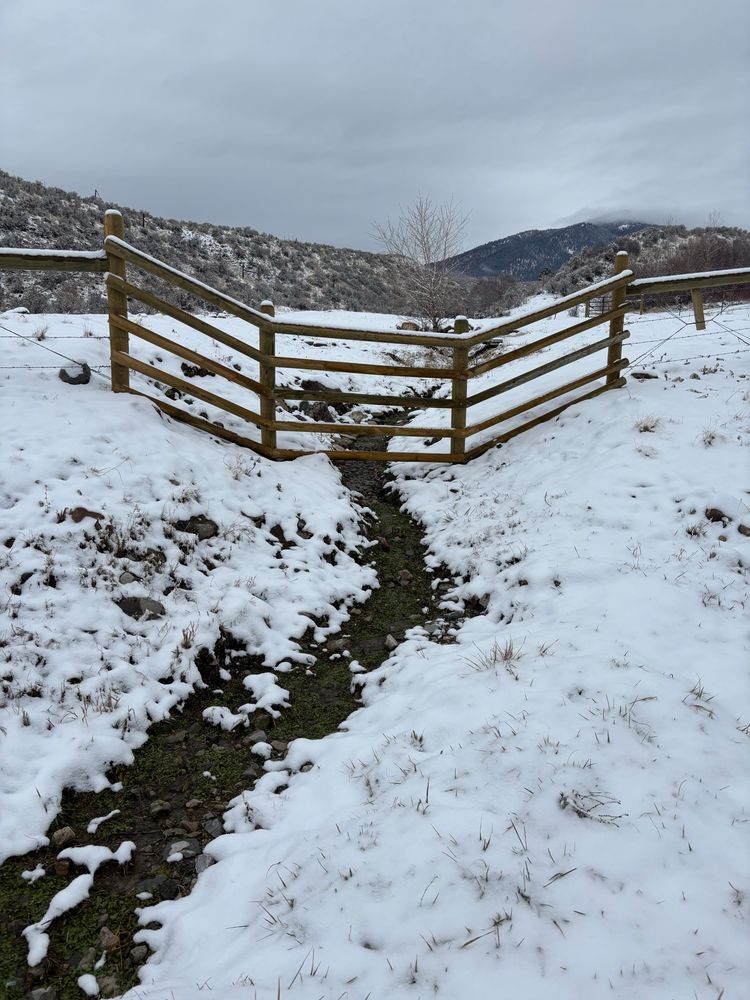 Snow on the banks of an almost dry small creek 