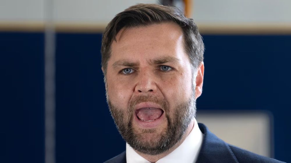 JD Vance, with his mouth wide open and an intense expression, gives opera singer vibes