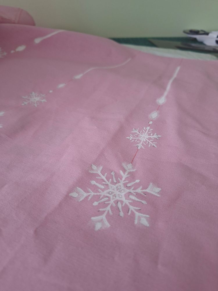 pink skirt material with delicate white snowflakes painted on it