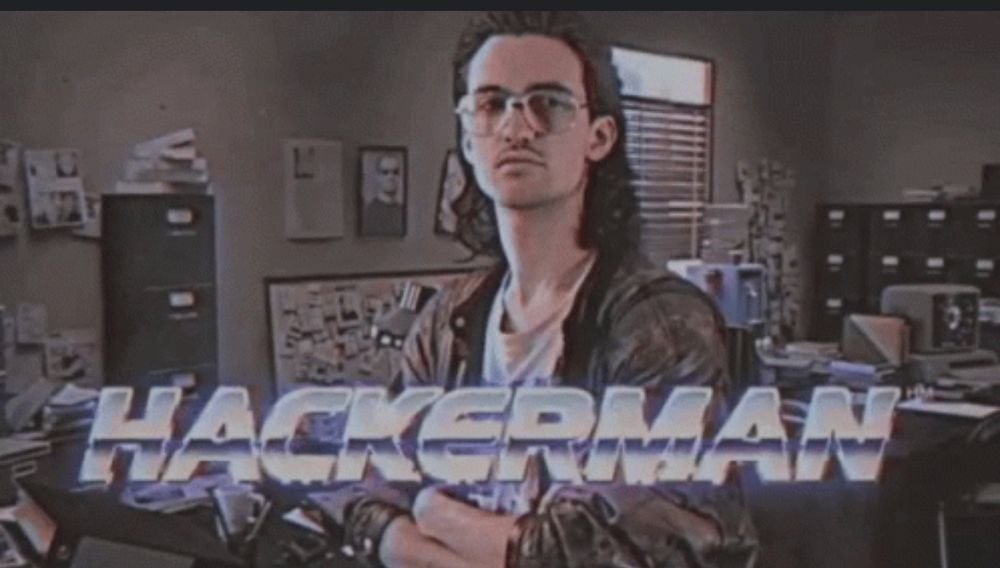 Picture of a man with glasses and a mullet. Caption reads HACKERMAN