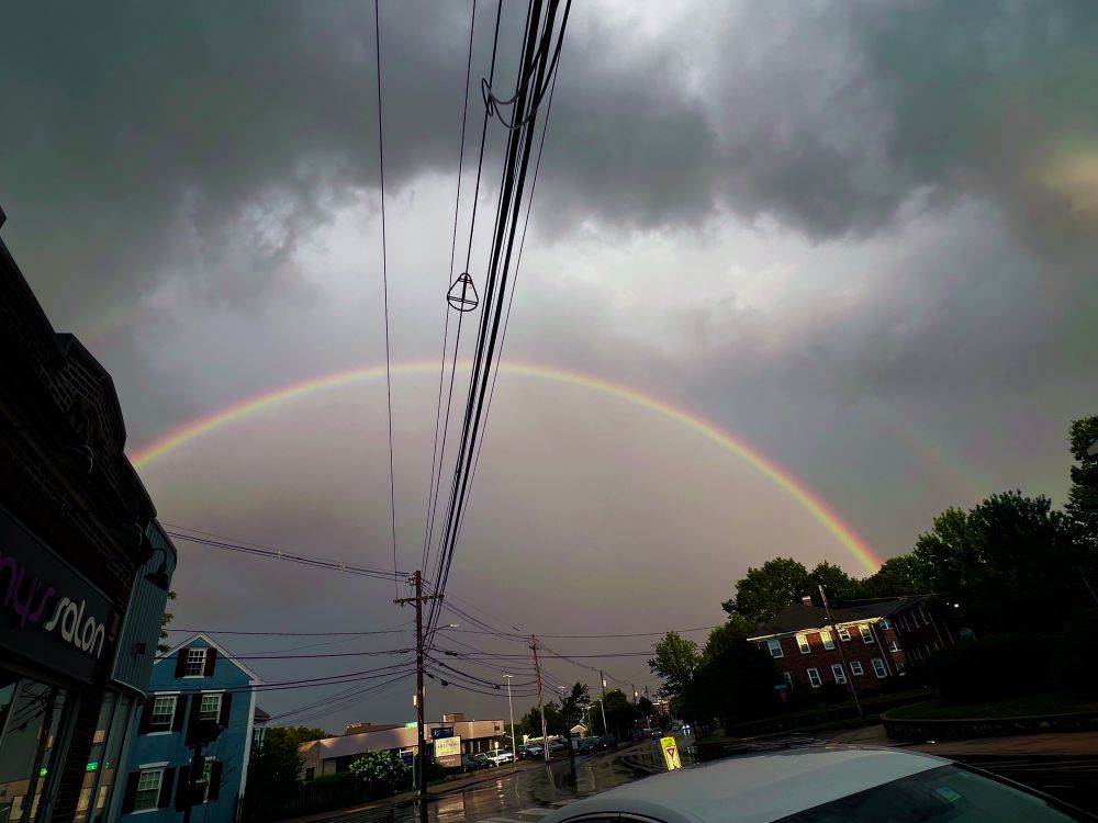 A double rainbow seen over a stormy sky