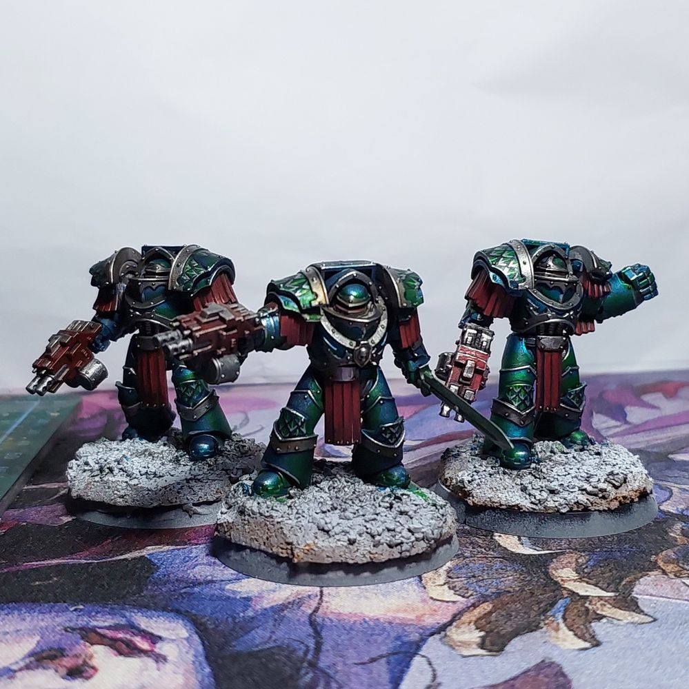 Three partially painted terminators in Alpha Legion colors.