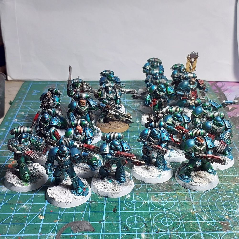 Twenty Alpha Legion space marines equipped with a wide variety of weapons.