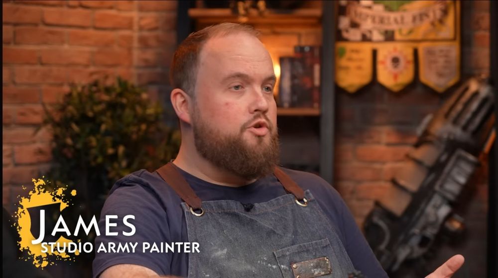 A screen shot of Games Workshop studio army painter James, in a YouTube video where he teaches army painting techniques