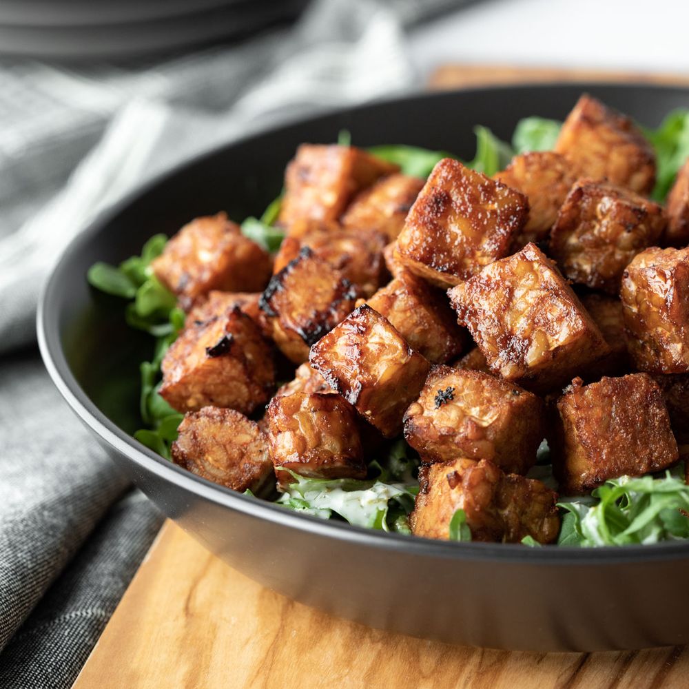 Cubed tempeh that was cooked in the air fryer resting in a bowl.